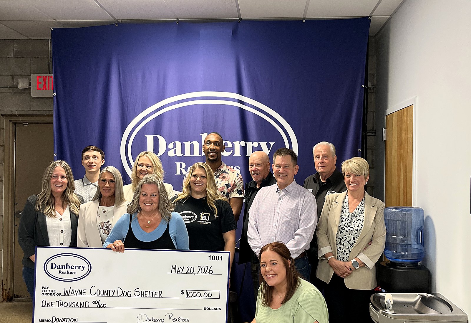 Danberry donation check to Wayne County Dog Shelter with agents and a rescue dog